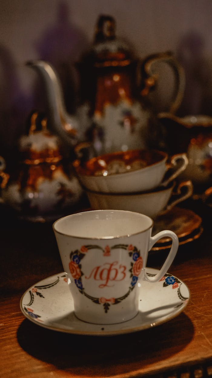 A beautifully crafted vintage porcelain tea set featuring ornate designs and muted colors.
